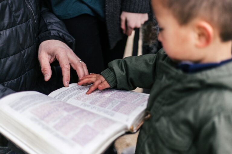 Kid touches page of a book